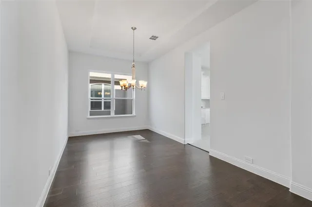 a view of a room with wooden floor and window