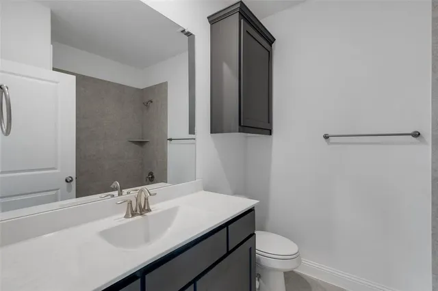 a bathroom with a sink toilet and a mirror