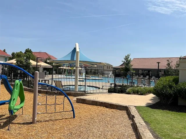a view of a house with backyard and sitting area