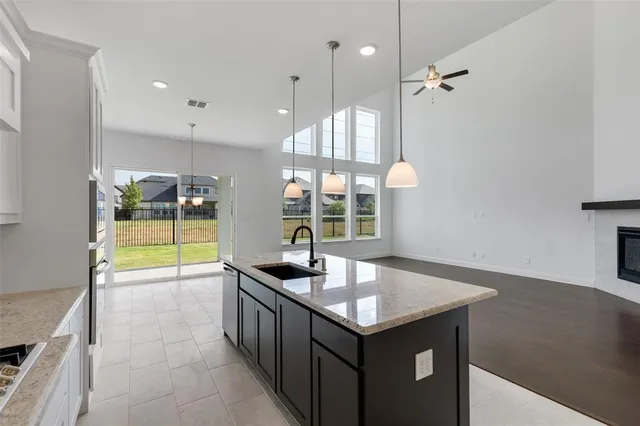 a kitchen with a sink cabinets and a large window