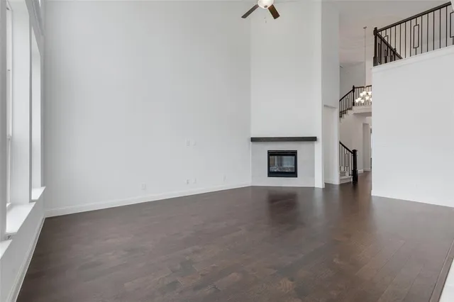 a view of a livingroom with wooden floor and a fireplace