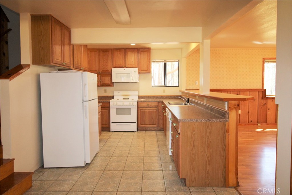 268 Milsap Bar Road Berry Creek, CA 95916 - Photo 8 of 47 a kitchen with a refrigerator a washer and dryer