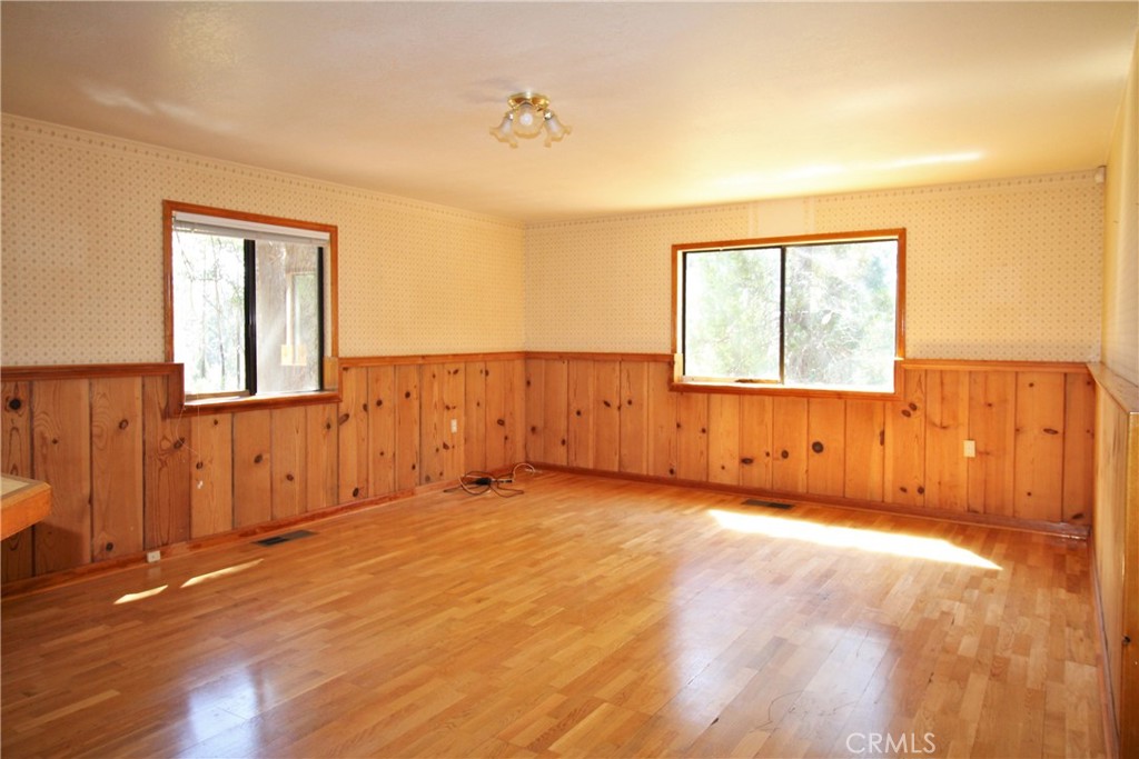 268 Milsap Bar Road Berry Creek, CA 95916 - Photo 9 of 47 an empty room with wooden floor and windows