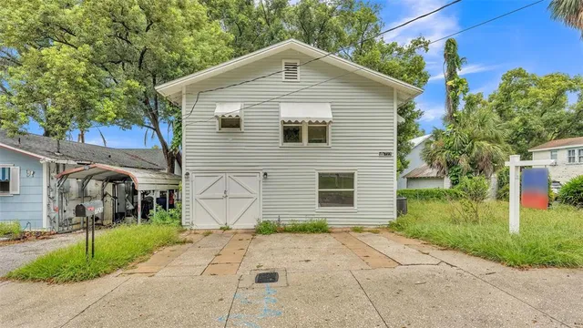 a front view of a house with a yard and a garage