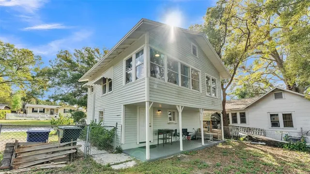 a front view of a house with chairs and table