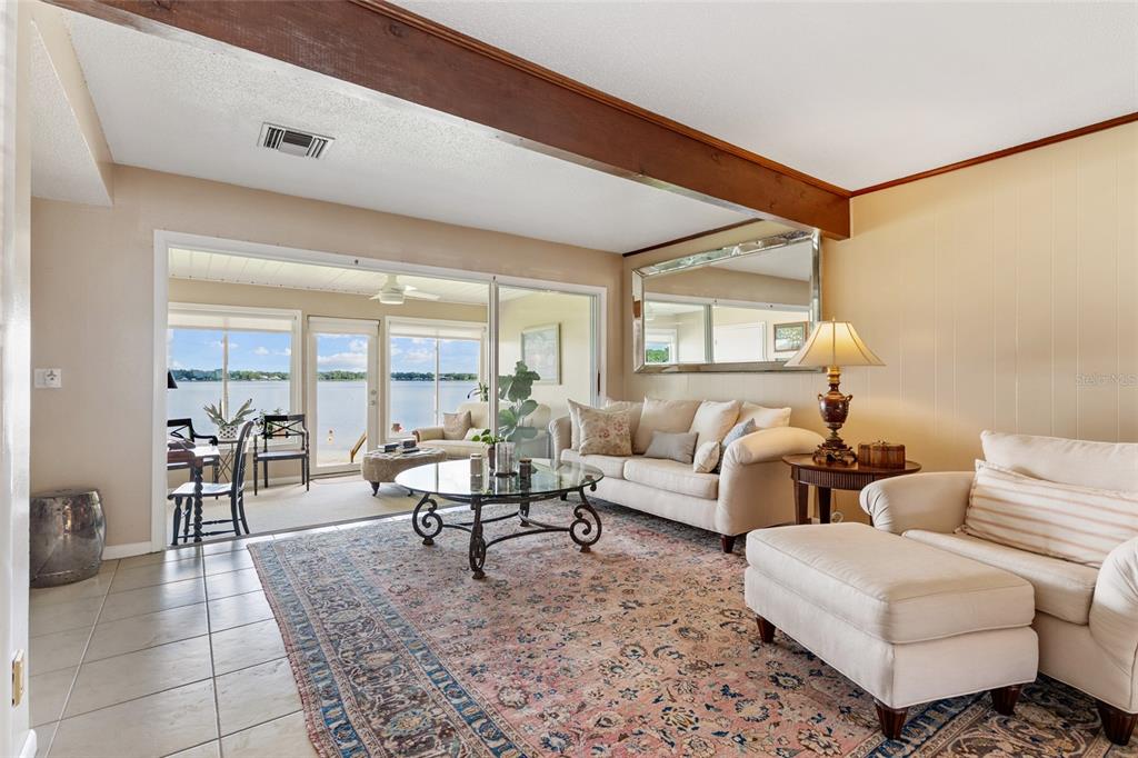 11001 Southeast Sunset Harbor Road, Unit B13 Summerfield, FL 34491 - Photo 11 of 50 a living room with furniture and a large window