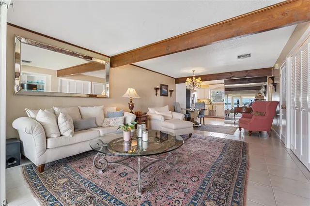 a living room with furniture a rug and a table