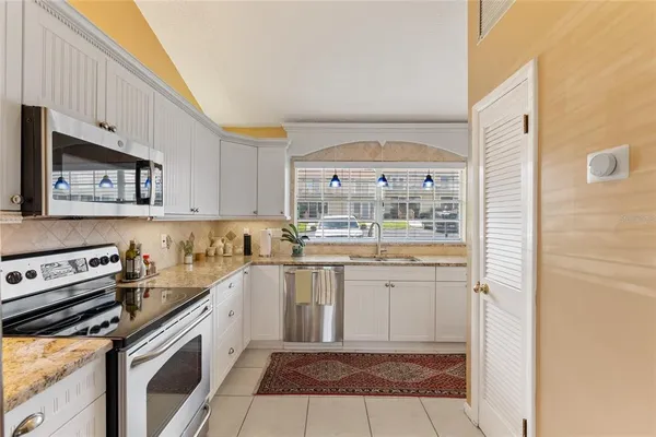 a kitchen with a sink stove and cabinets
