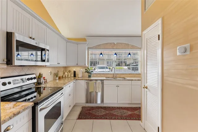a kitchen with a sink stove and cabinets