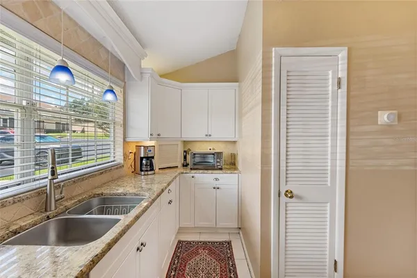 a kitchen with a sink a counter top space and cabinets