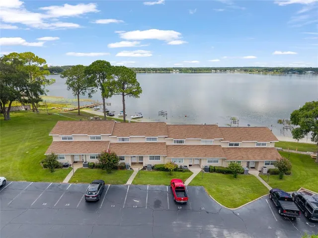 an aerial view of a house with outdoor space and lake view