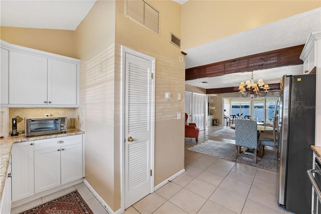 11001 Southeast Sunset Harbor Road, Unit B13 Summerfield, FL 34491 - Photo 22 of 50 a view of a kitchen with fridge and workspace