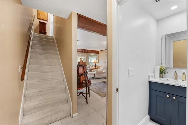 a view of a hallway with wooden floor and staircase