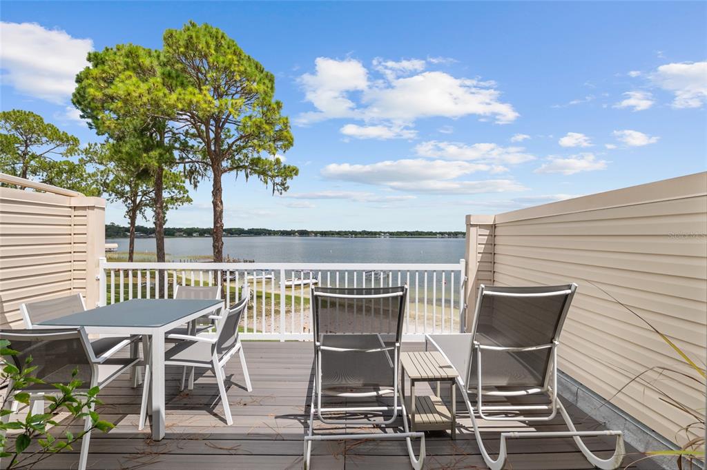 11001 Southeast Sunset Harbor Road, Unit B13 Summerfield, FL 34491 - Photo 28 of 50 a view of a patio with table and chairs and potted plants