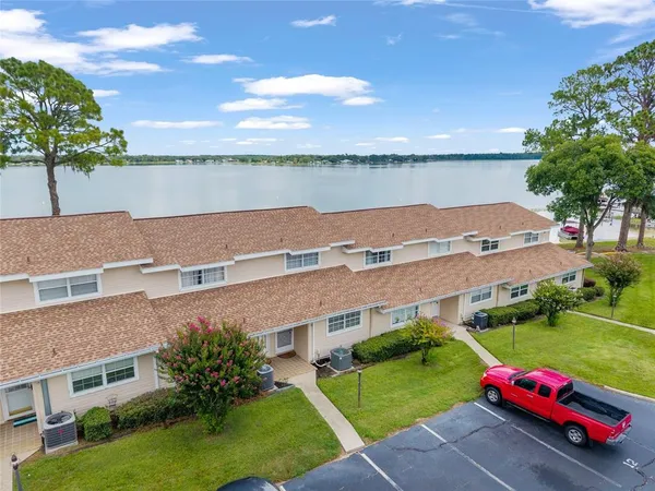 an aerial view of multiple houses with yard