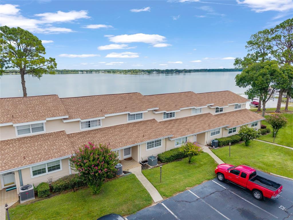 11001 Southeast Sunset Harbor Road, Unit B13 Summerfield, FL 34491 - Photo 3 of 50 an aerial view of multiple houses with yard
