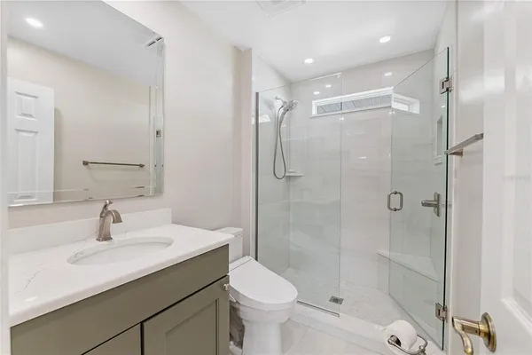 a bathroom with a sink toilet and shower