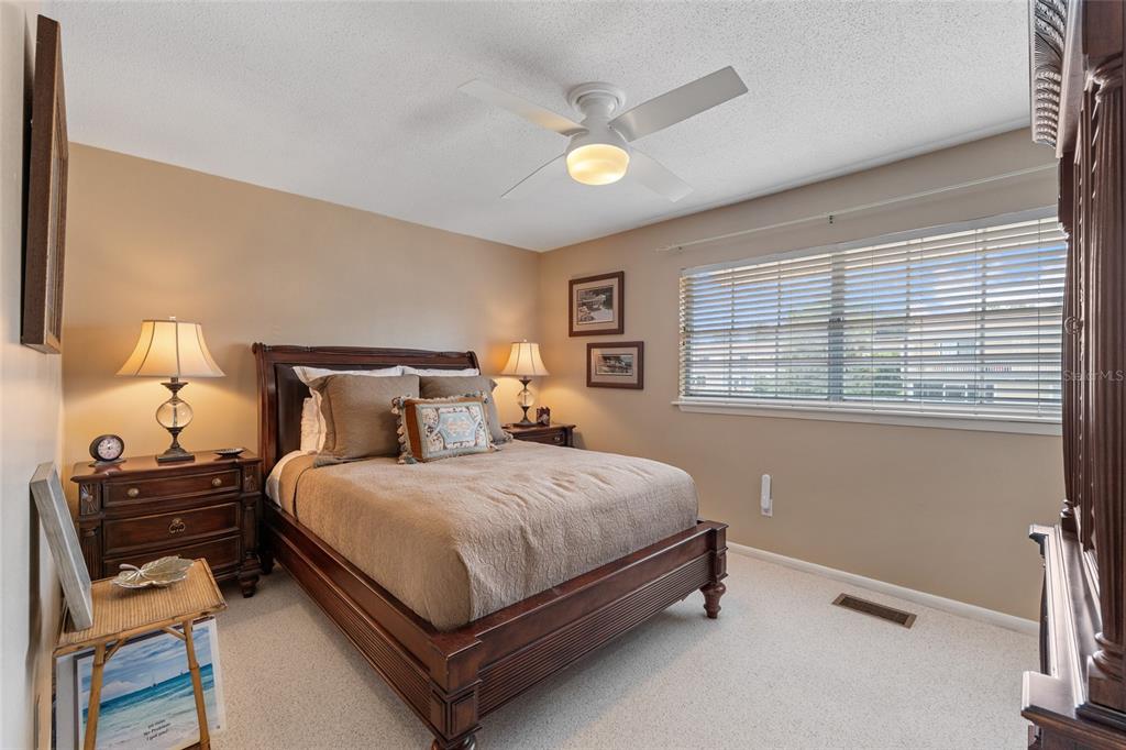 11001 Southeast Sunset Harbor Road, Unit B13 Summerfield, FL 34491 - Photo 33 of 50 a bedroom with a bed and a window