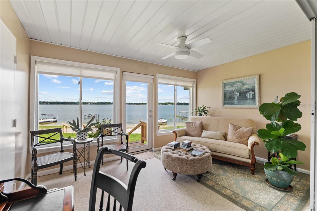 11001 Southeast Sunset Harbor Road, Unit B13 Summerfield, FL 34491 - Photo 37 of 50 a living room with furniture and floor to ceiling windows