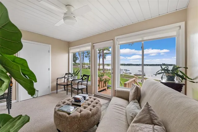 a living room with furniture and a large window with garden view