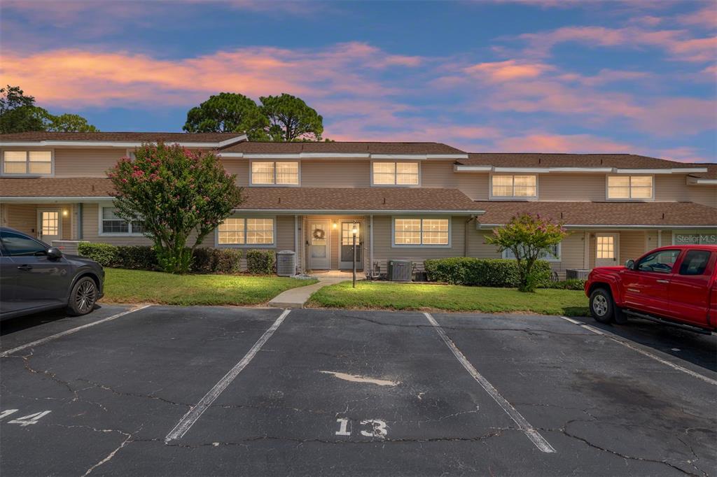 11001 Southeast Sunset Harbor Road, Unit B13 Summerfield, FL 34491 - Photo 42 of 50 a front view of a house with a yard and garage