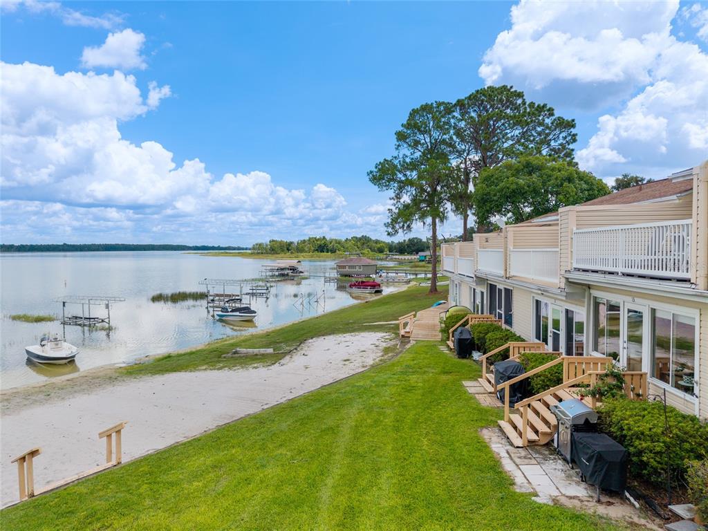 11001 Southeast Sunset Harbor Road, Unit B13 Summerfield, FL 34491 - Photo 45 of 50 a view of a house with swimming pool and sitting area