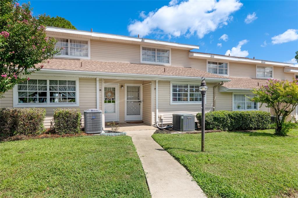 11001 Southeast Sunset Harbor Road, Unit B13 Summerfield, FL 34491 - Photo 5 of 50 a view of a house with a yard and plants