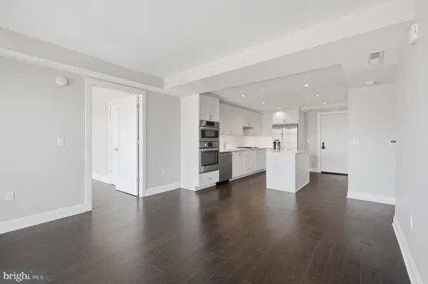 a view of an empty room with a kitchen