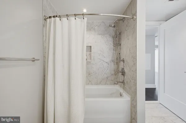 a bathroom with a shower and a bath tub