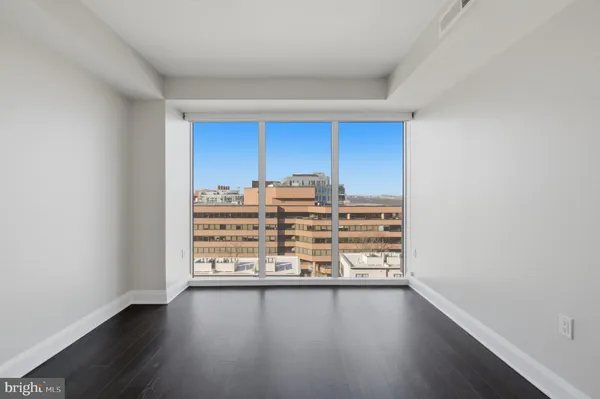 a view of a room with wooden floor and window