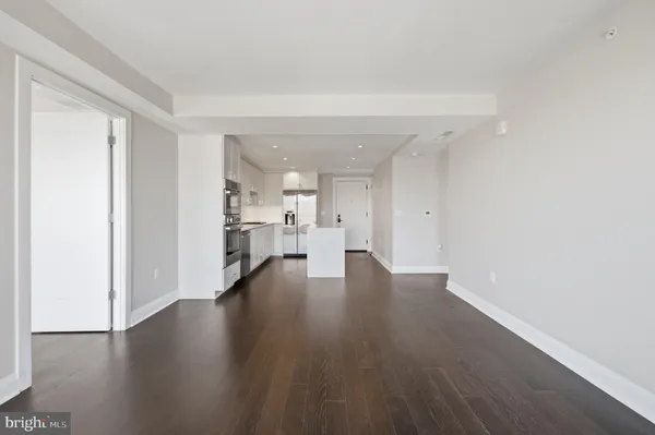 a view of a kitchen with wooden floor and a kitchen