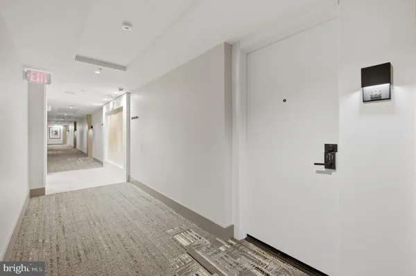 a view of hallway with wooden floor