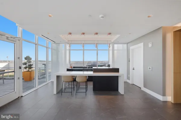 a view of roof deck with seating space and wooden floor