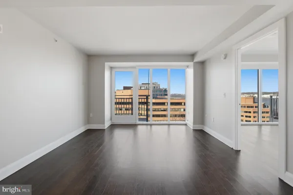a view of a kitchen with wooden floor and electronic appliances