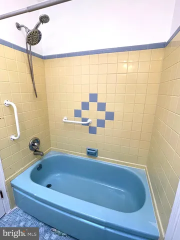 a bathroom with a tub and a shower