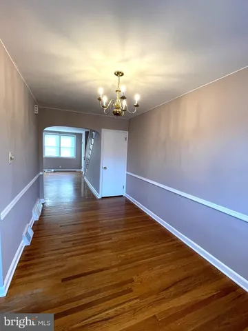 a view of wooden floor and chandelier in a room