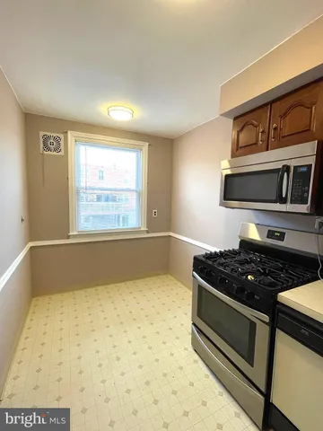 a kitchen with granite countertop a stove and a cabinet