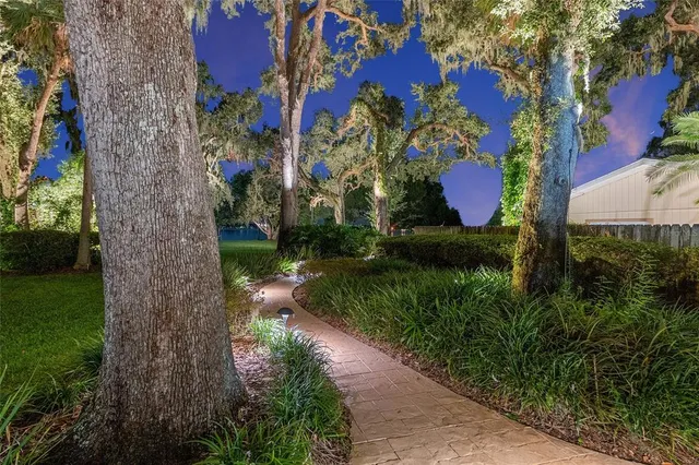 a bedroom with a bed a couch and a chandelier