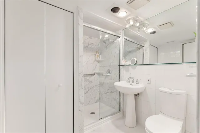 a kitchen with stainless steel appliances granite countertop a stove top oven a sink dishwasher a dining table and chairs with wooden floor