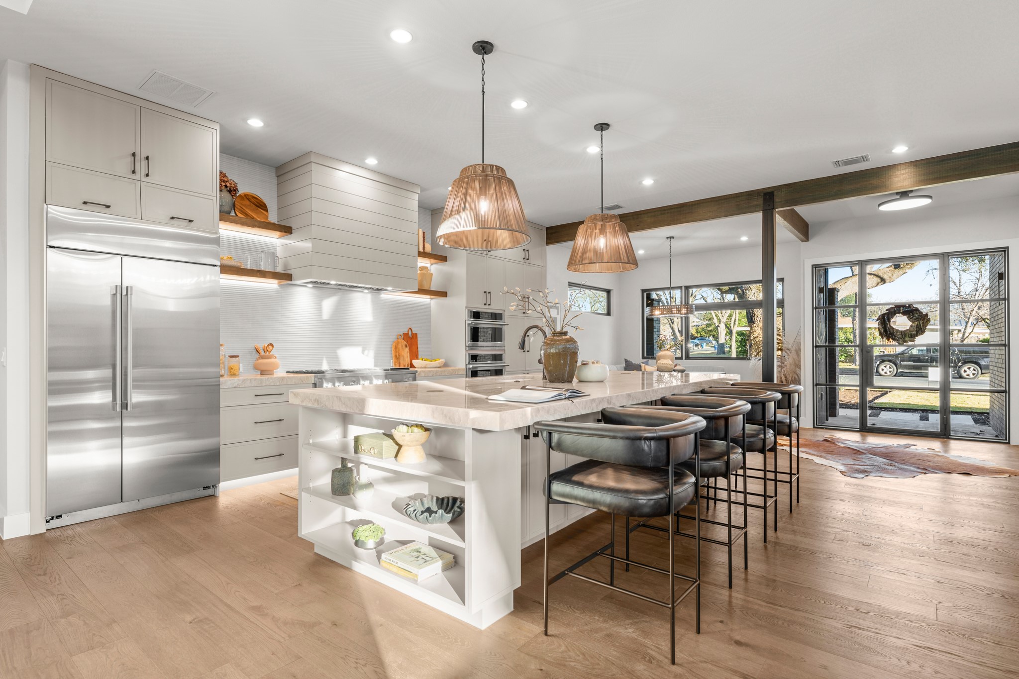 7706 Rutgers Avenue Austin, TX 78757 - Photo 8 of 35 Kitchen with open shelves, appliances with stainless steel finishes, a spacious island, hanging light fixtures, and a breakfast bar