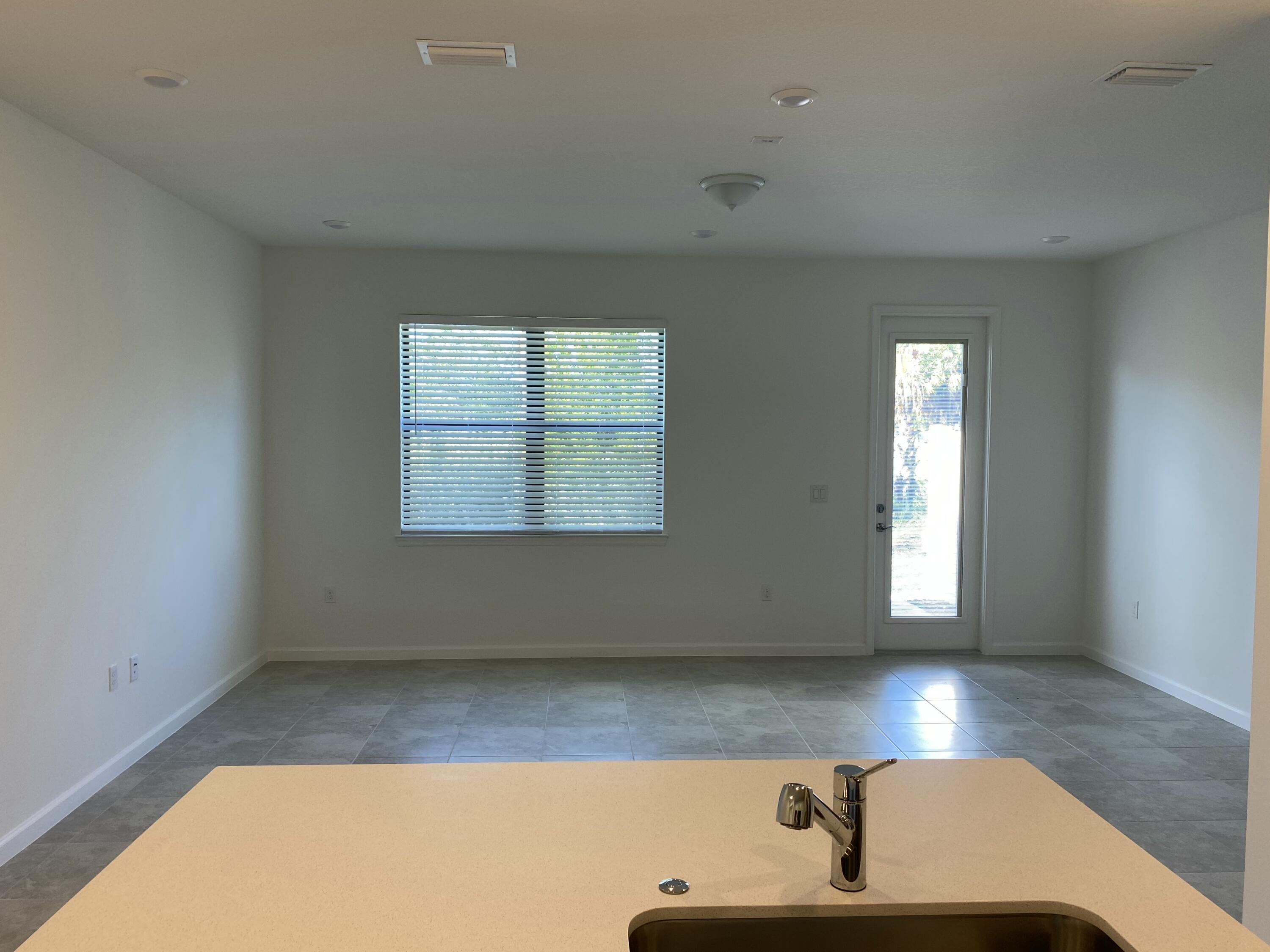 2788 Tennis Club Drive, Unit 102 West Palm Beach, FL 33417 - Photo 13 of 26 an empty room with windows