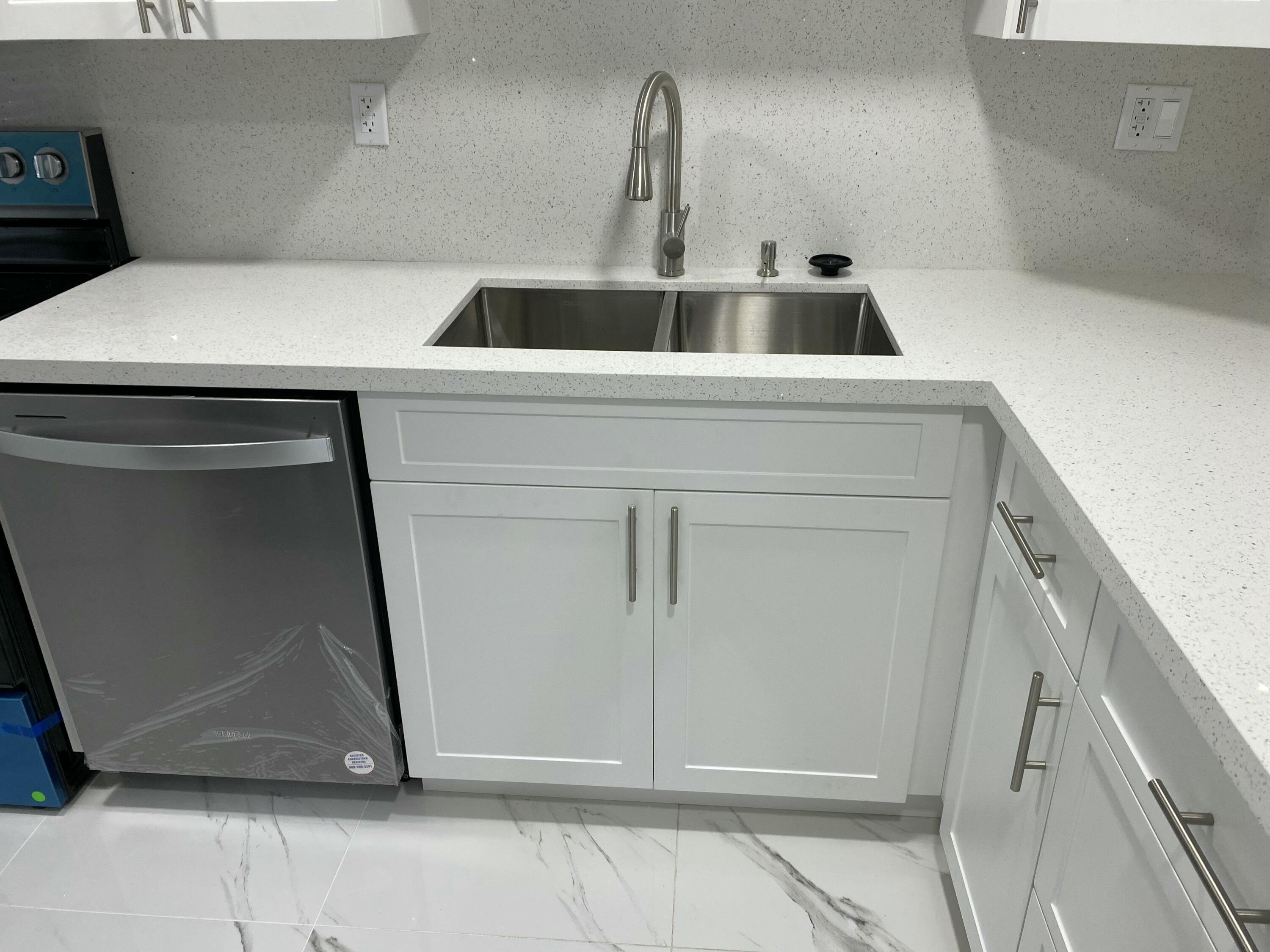 2788 Tennis Club Drive, Unit 102 West Palm Beach, FL 33417 - Photo 14 of 26 a bathroom with a sink and mirror