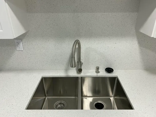 a view of a kitchen with a sink and cabinet area