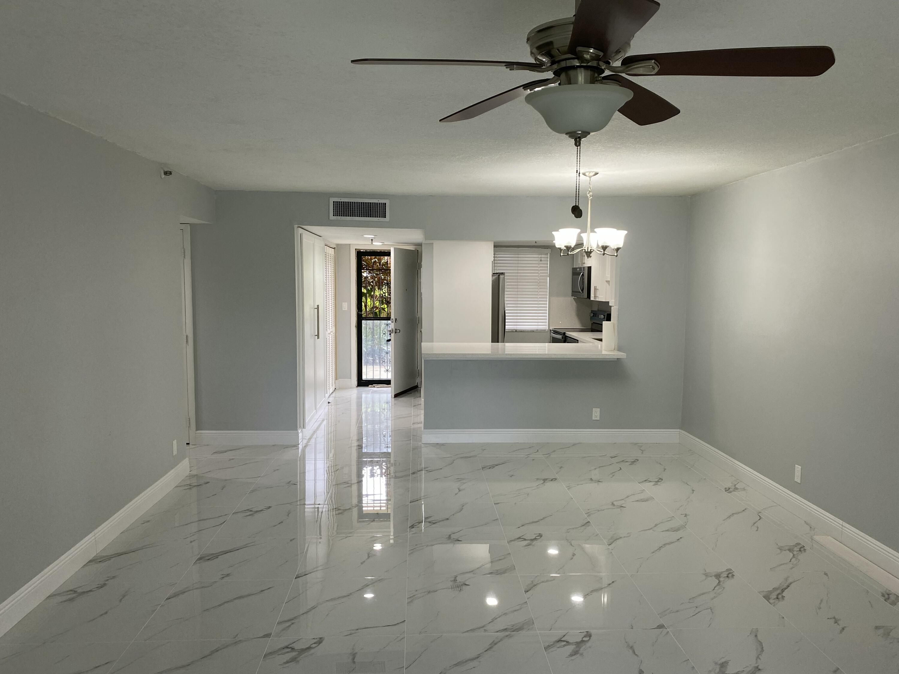 2788 Tennis Club Drive, Unit 102 West Palm Beach, FL 33417 - Photo 17 of 26 a view of a kitchen with a sink and cabinet area