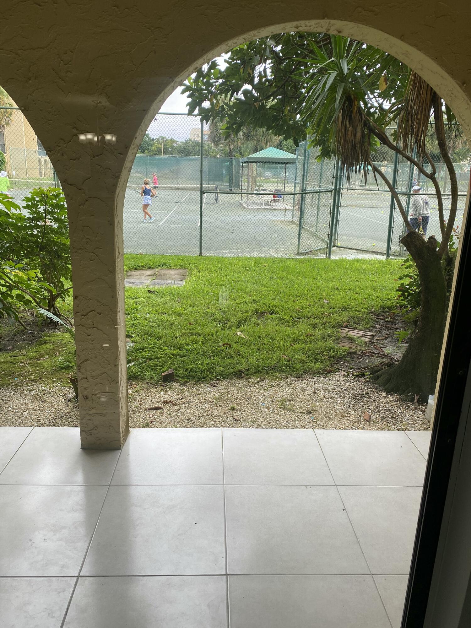 2788 Tennis Club Drive, Unit 102 West Palm Beach, FL 33417 - Photo 19 of 26 a view of backyard with tree