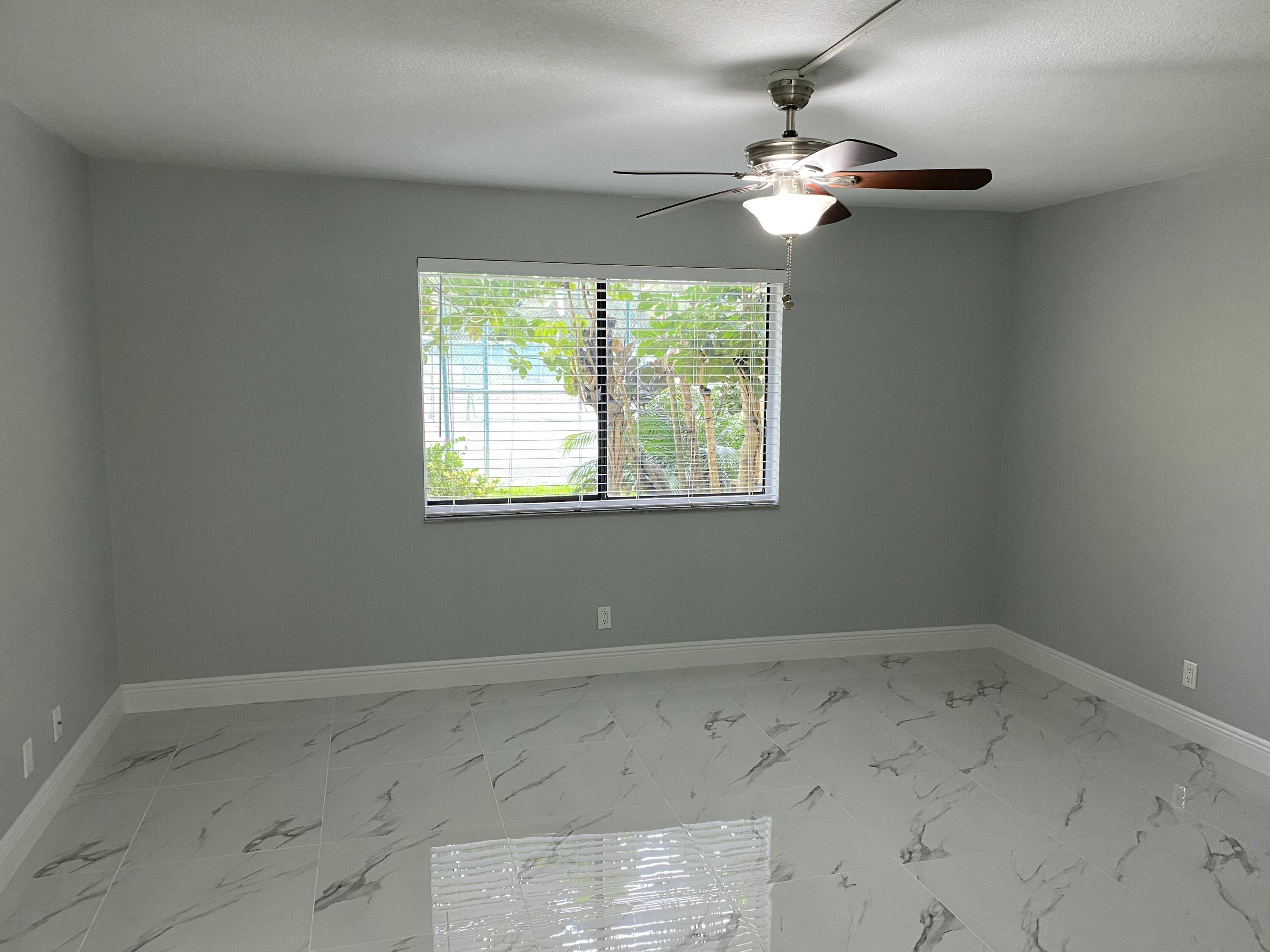 2788 Tennis Club Drive, Unit 102 West Palm Beach, FL 33417 - Photo 23 of 26 an empty room with a window