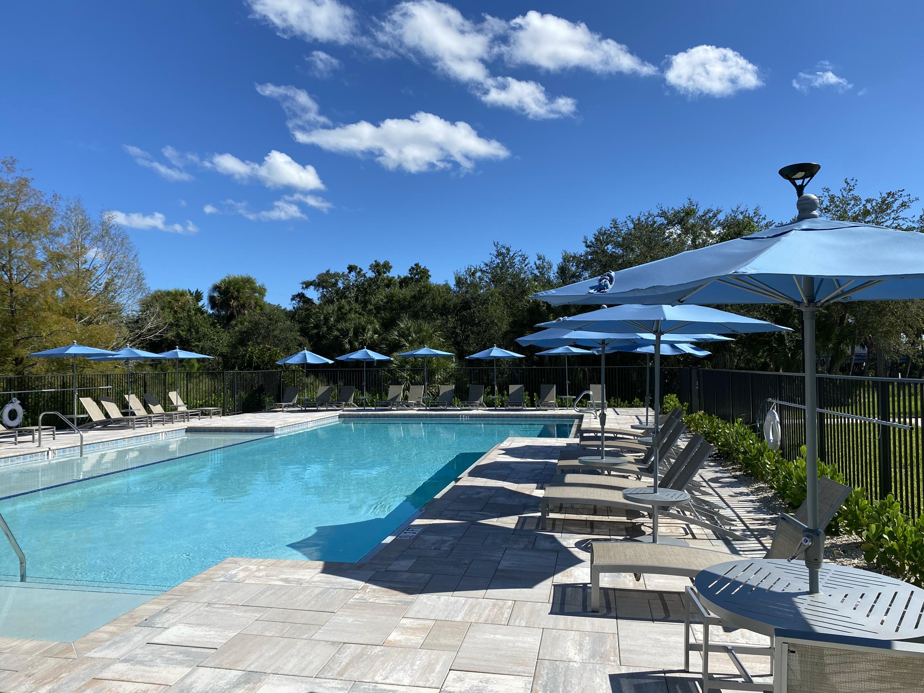 2788 Tennis Club Drive, Unit 102 West Palm Beach, FL 33417 - Photo 24 of 26 a view of a swimming pool with a patio