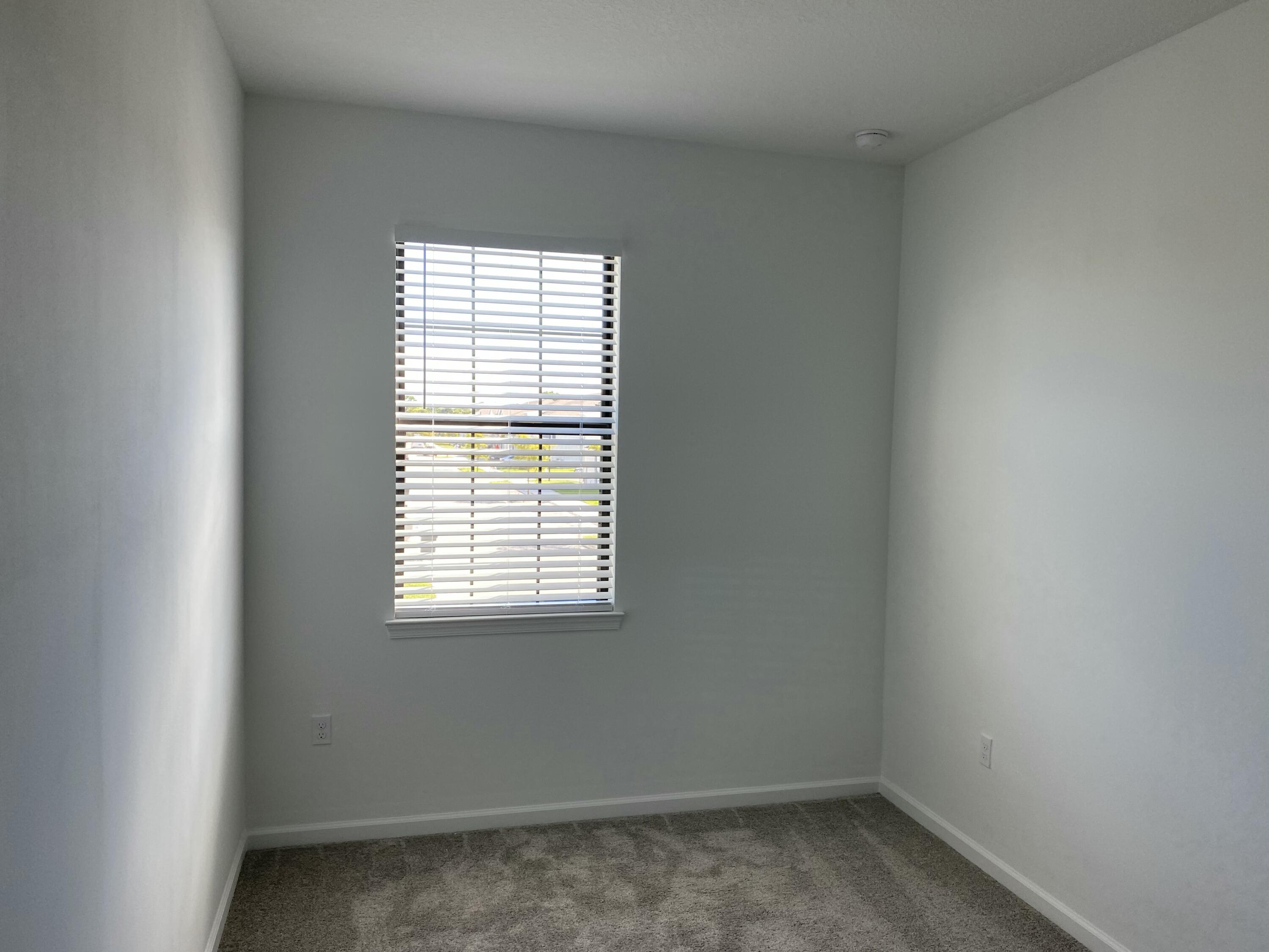 2788 Tennis Club Drive, Unit 102 West Palm Beach, FL 33417 - Photo 6 of 26 an empty room with a window