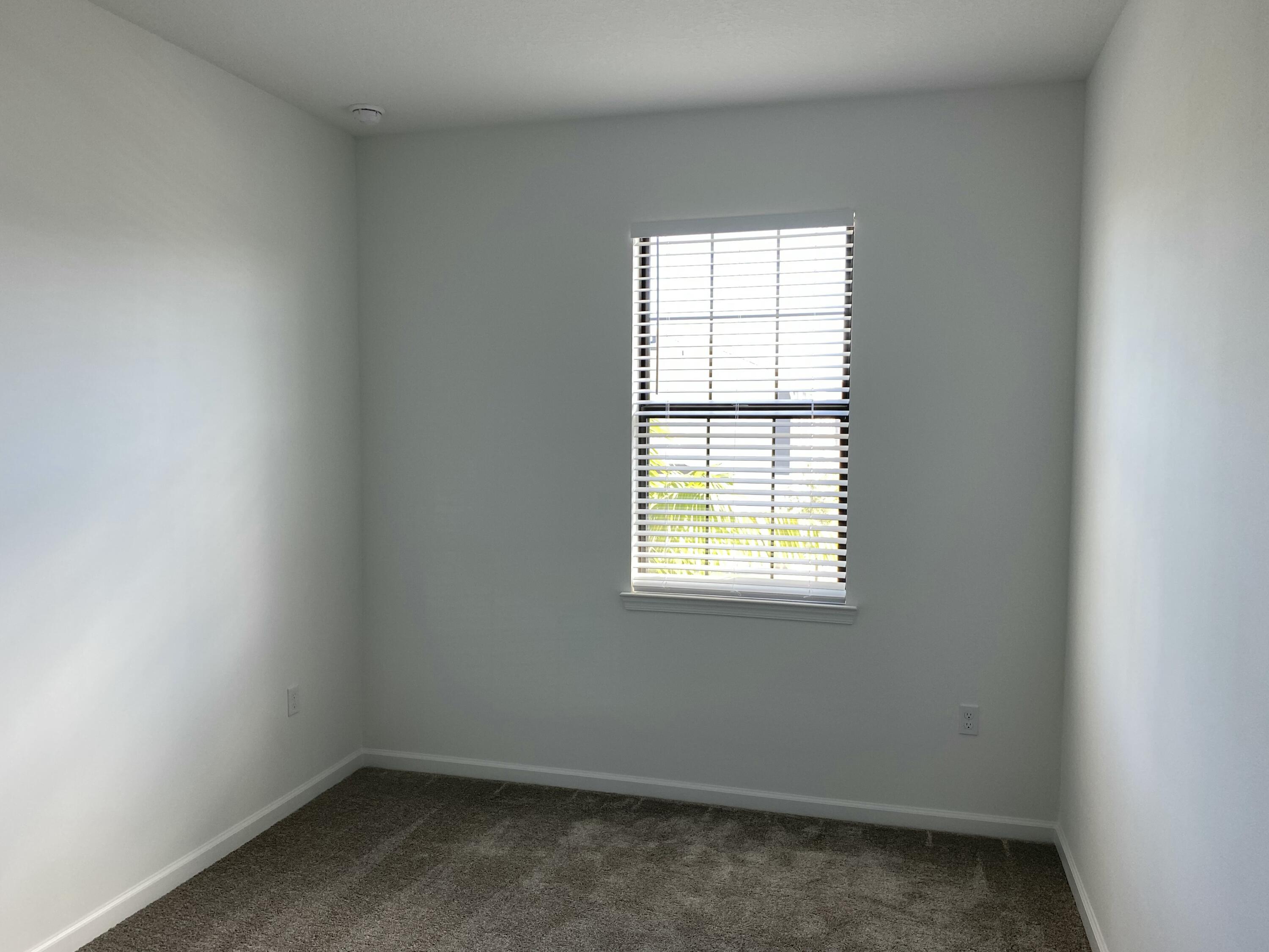 2788 Tennis Club Drive, Unit 102 West Palm Beach, FL 33417 - Photo 7 of 26 an empty room with a window