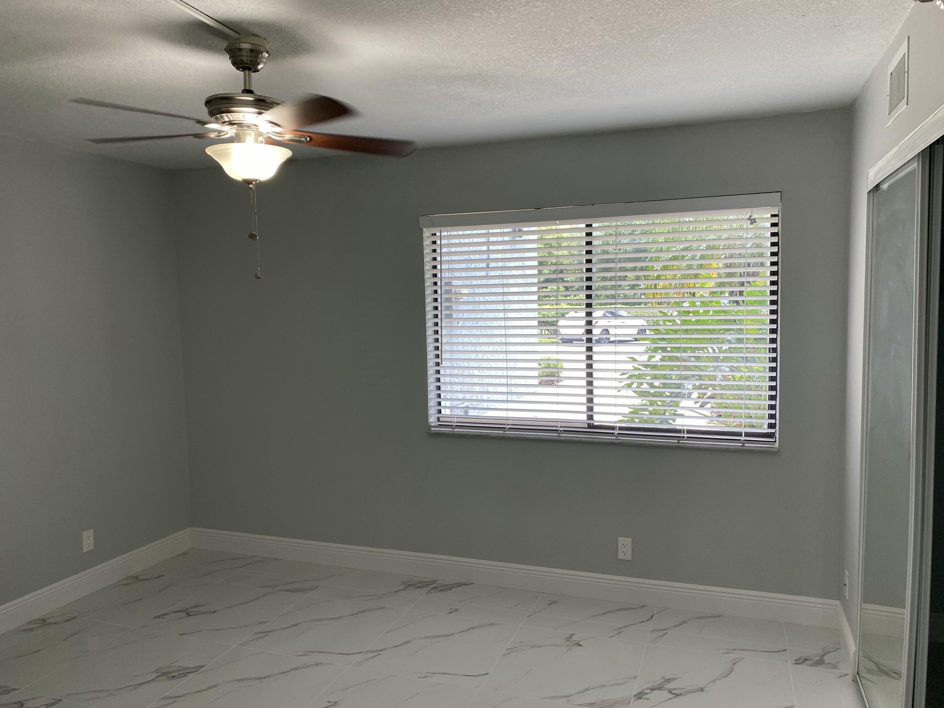 2788 Tennis Club Drive, Unit 102 West Palm Beach, FL 33417 - Photo 10 of 26 a view of a livingroom with a chandelier fan